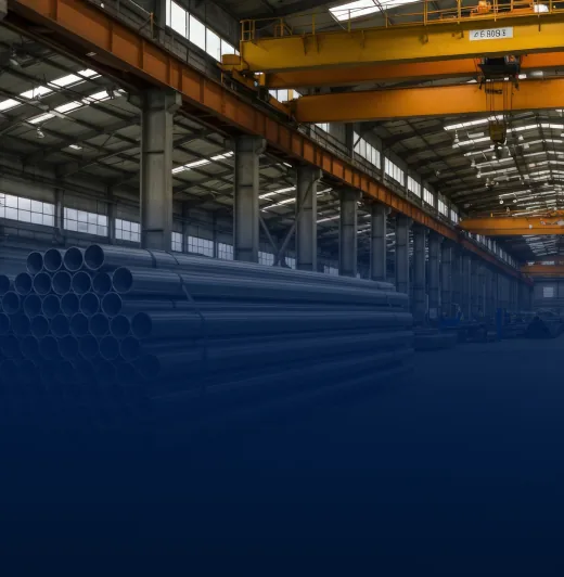 Yellow electric overhead travelling crane spanning a warehouse aisle with steel pipes
